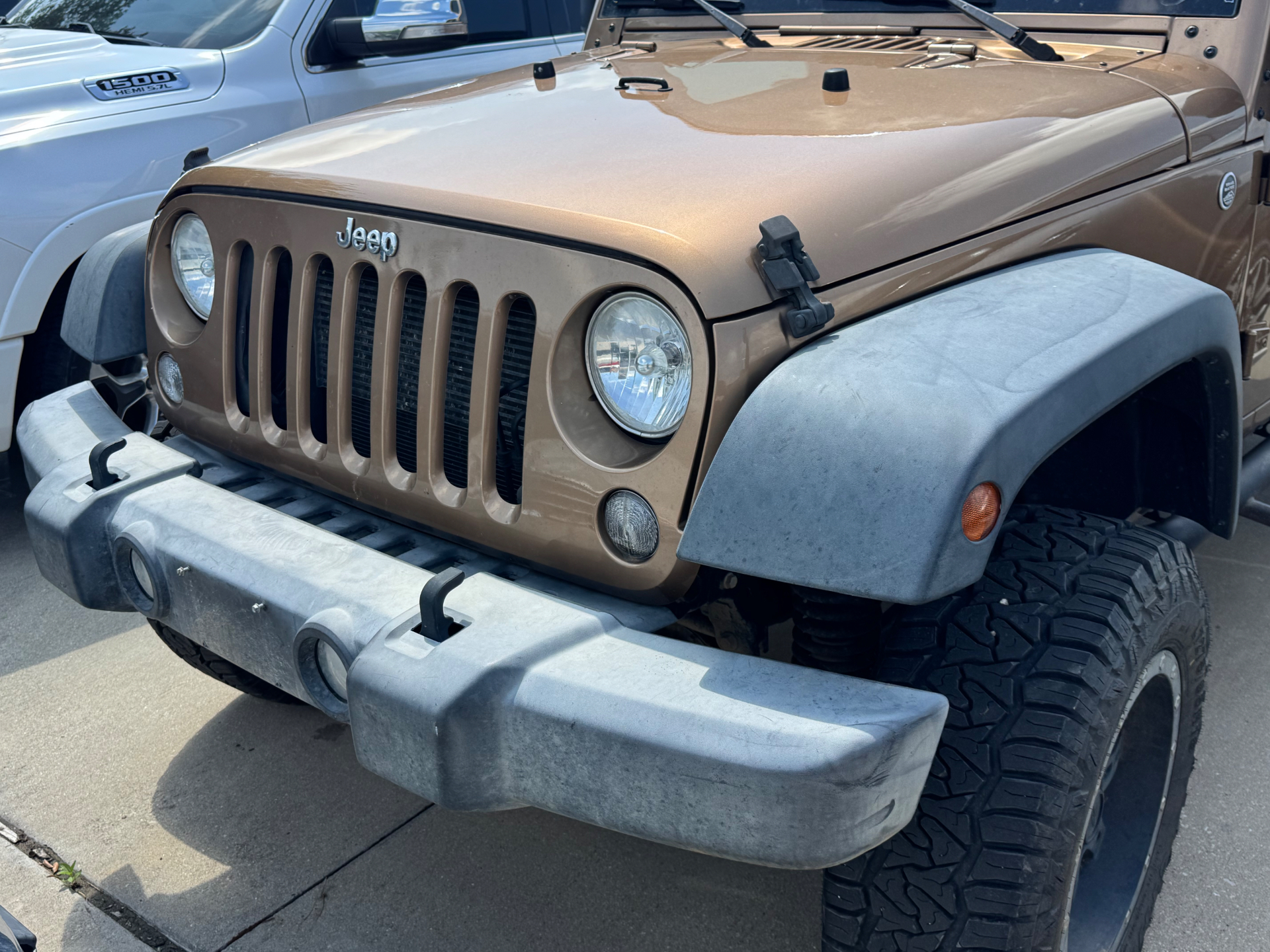 Before photo of faded Jeep Wrangler front bumper and fender flare