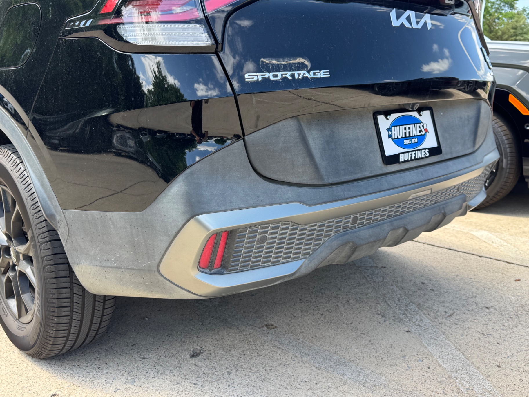 Before photo of faded gray Kia Sportage rear lower bumper trim