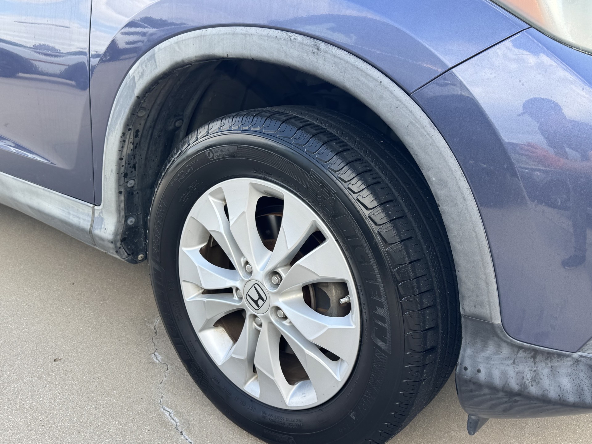 Before photo of faded front fender flare on blue Honda CR-V